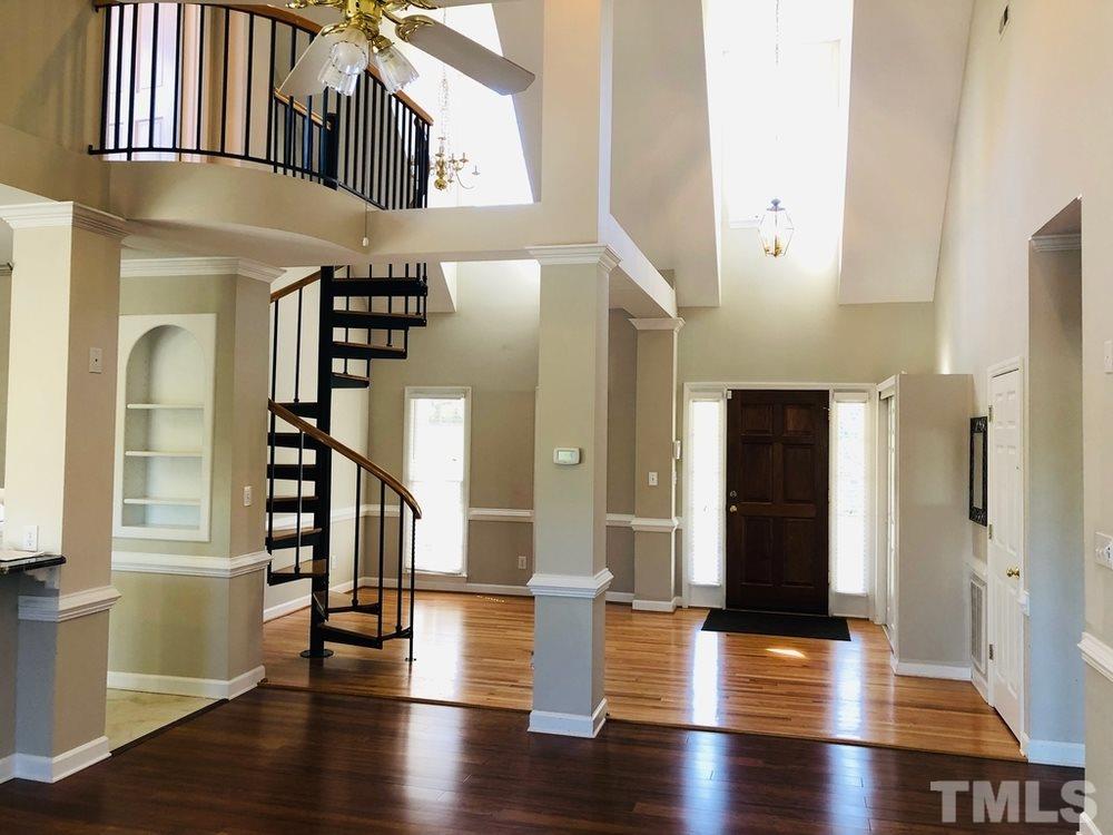 4309 Willow Lake Road Raleigh, NC 27616 - Photo 4 of 30 a view of an entryway with wooden floor and stairs