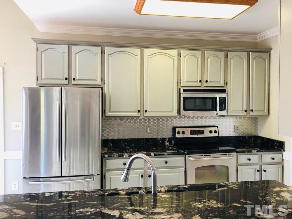 4309 Willow Lake Road Raleigh, NC 27616 - Photo 6 of 30 a kitchen with stainless steel appliances granite countertop a refrigerator a stove and a microwave