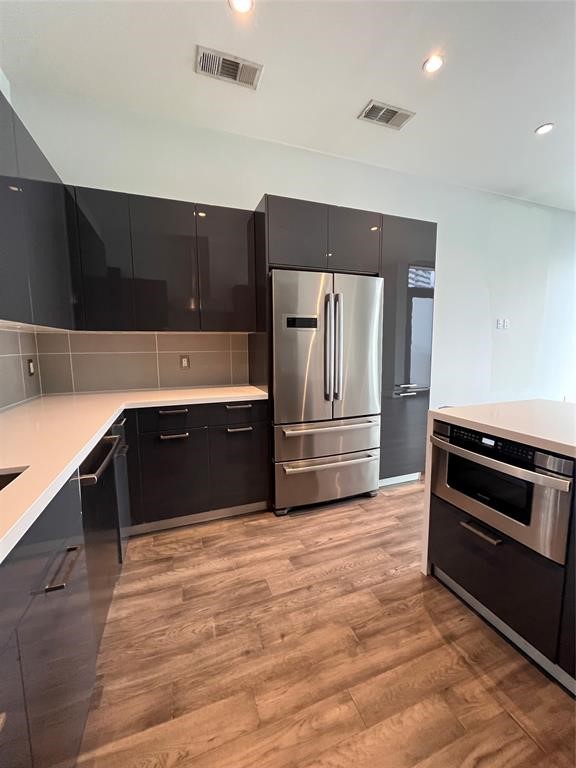 1211 Caroline Street, Unit 1708 Houston, TX 77002 - Photo 18 of 30 a kitchen with granite countertop a refrigerator and a stove