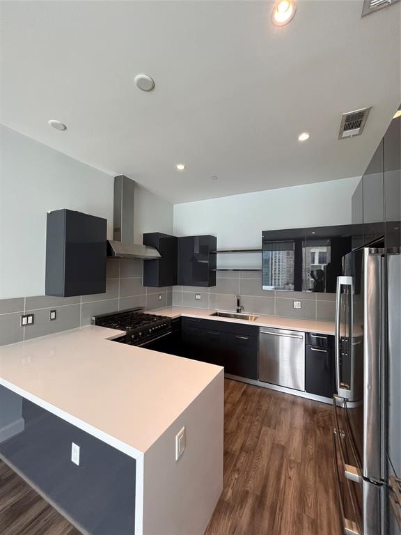 1211 Caroline Street, Unit 1708 Houston, TX 77002 - Photo 21 of 30 a large kitchen with stainless steel appliances a sink and a refrigerator