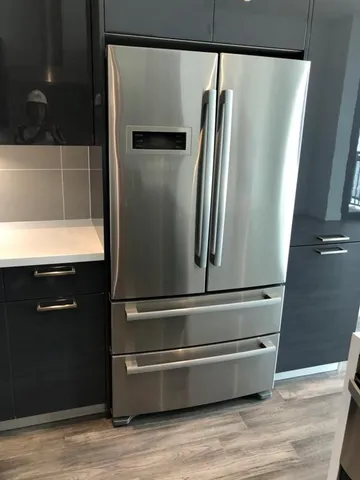 a stove top oven sitting inside of a kitchen