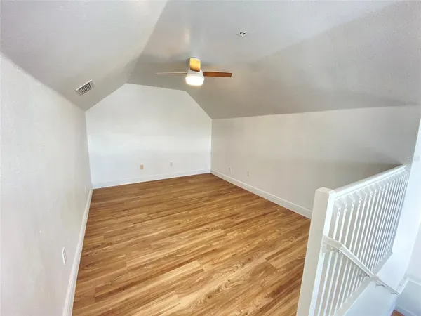 a view of a room with wooden floor