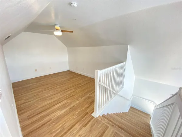 a view of a room with wooden floor