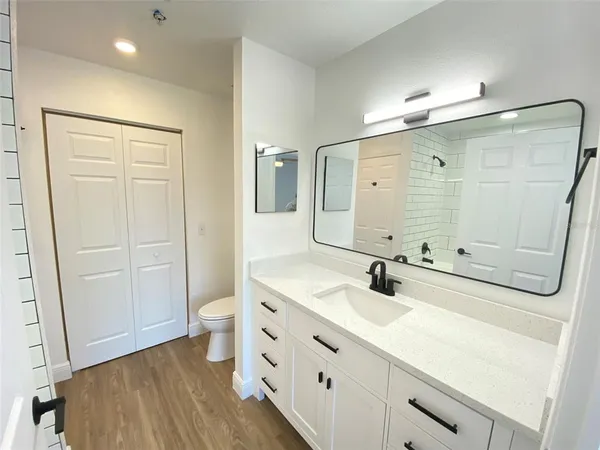 a bathroom with a double vanity sink and mirror with shower