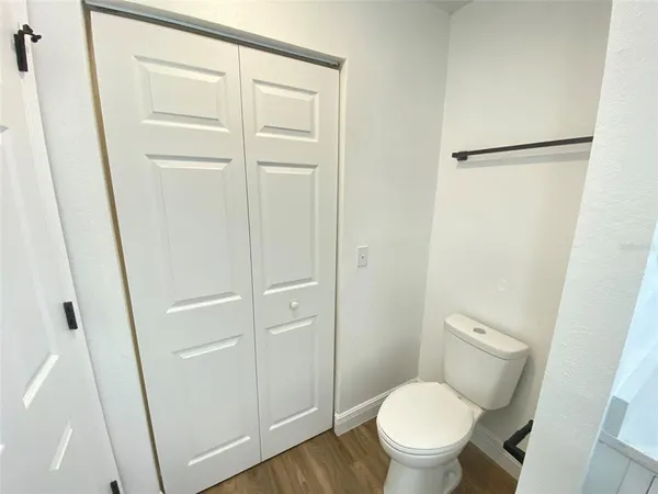 a white toilet sitting next to a sink