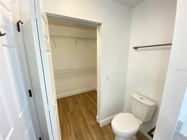 a white toilet sitting next to a shower