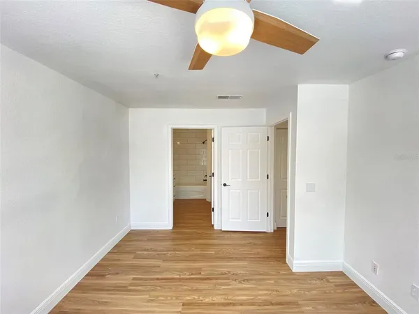 a view of a room with wooden floor
