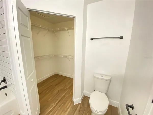 a white toilet sitting next to a bathroom sink