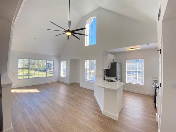 a view of a kitchen with wooden floor and a window