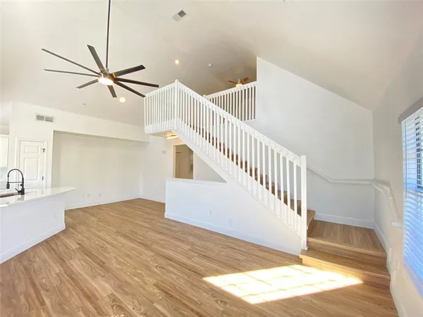 a view of a hallway with a ceiling fan