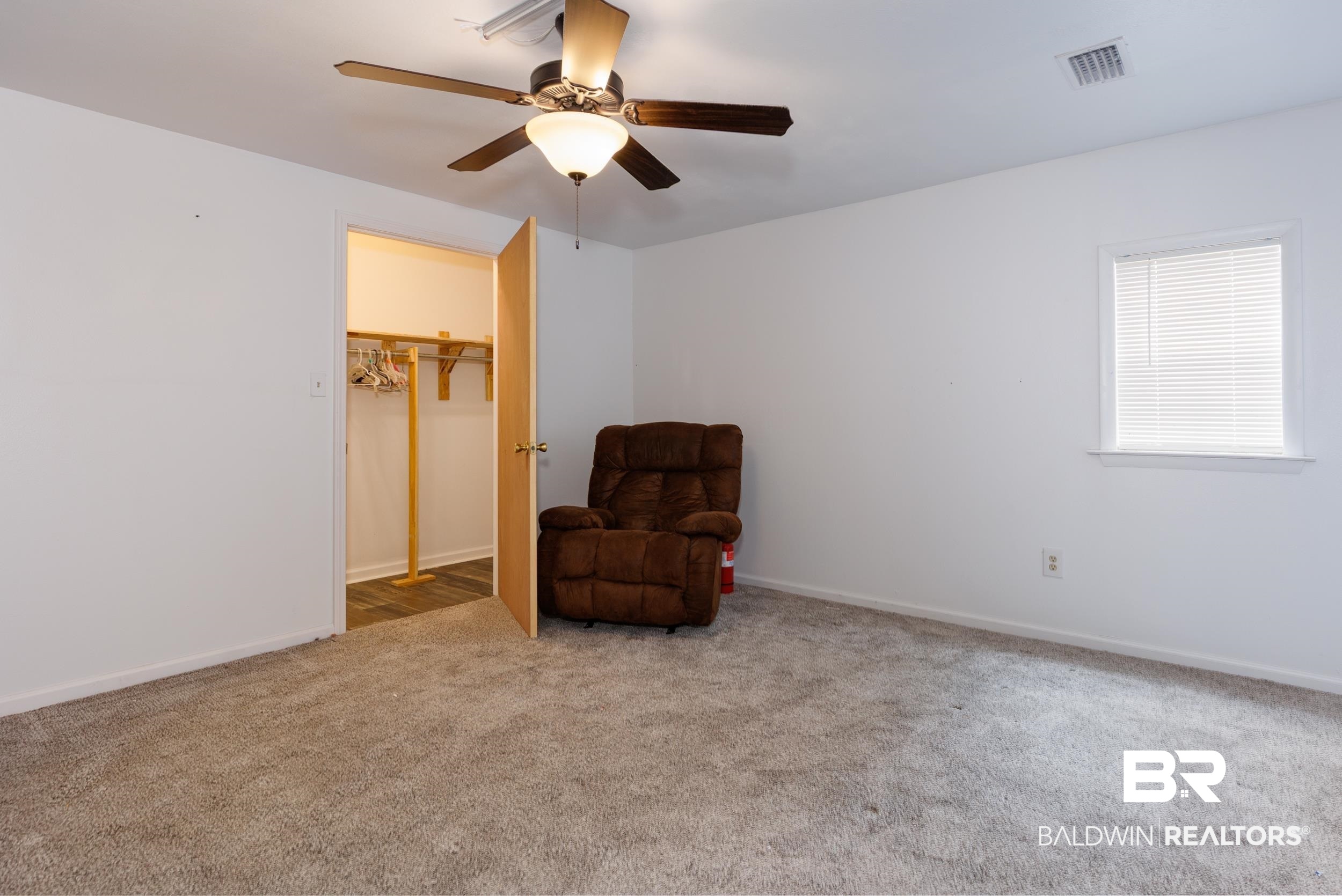 6725 Upper Creek Road Flomaton, AL 36441 - Photo 61 of 61 Sitting room with carpet floors, a ceiling fan, and baseboards