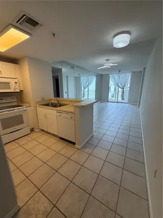 a kitchen with stainless steel appliances a sink and cabinets