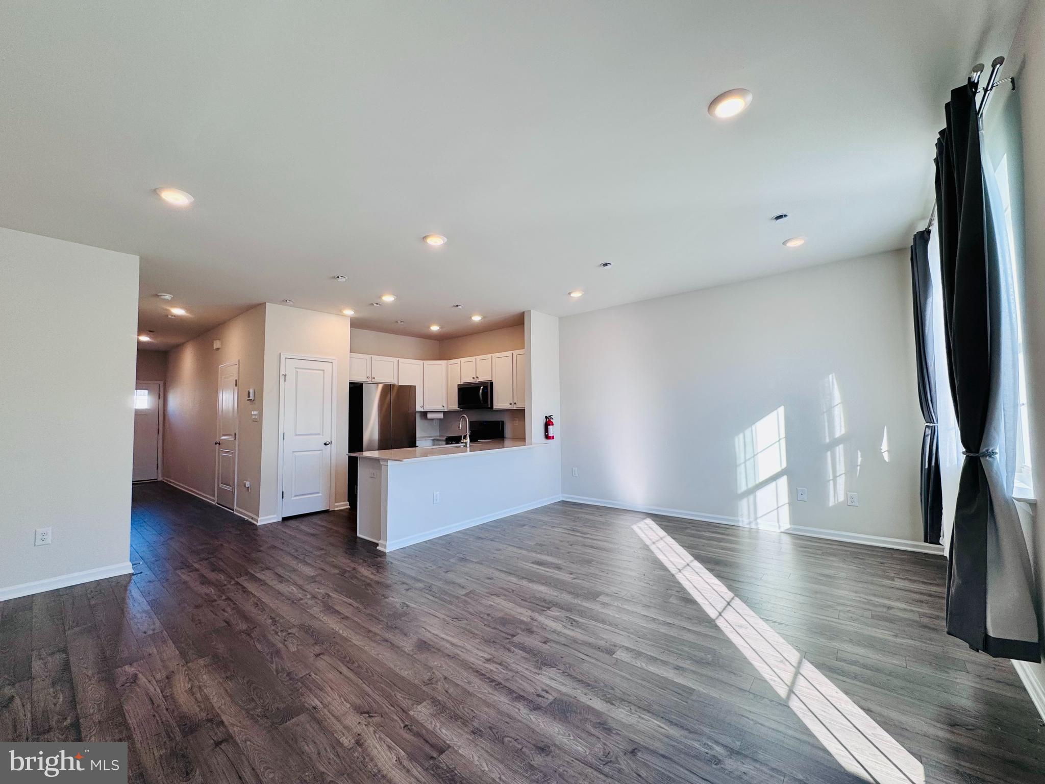 a view of kitchen with cabinets and wooden floor