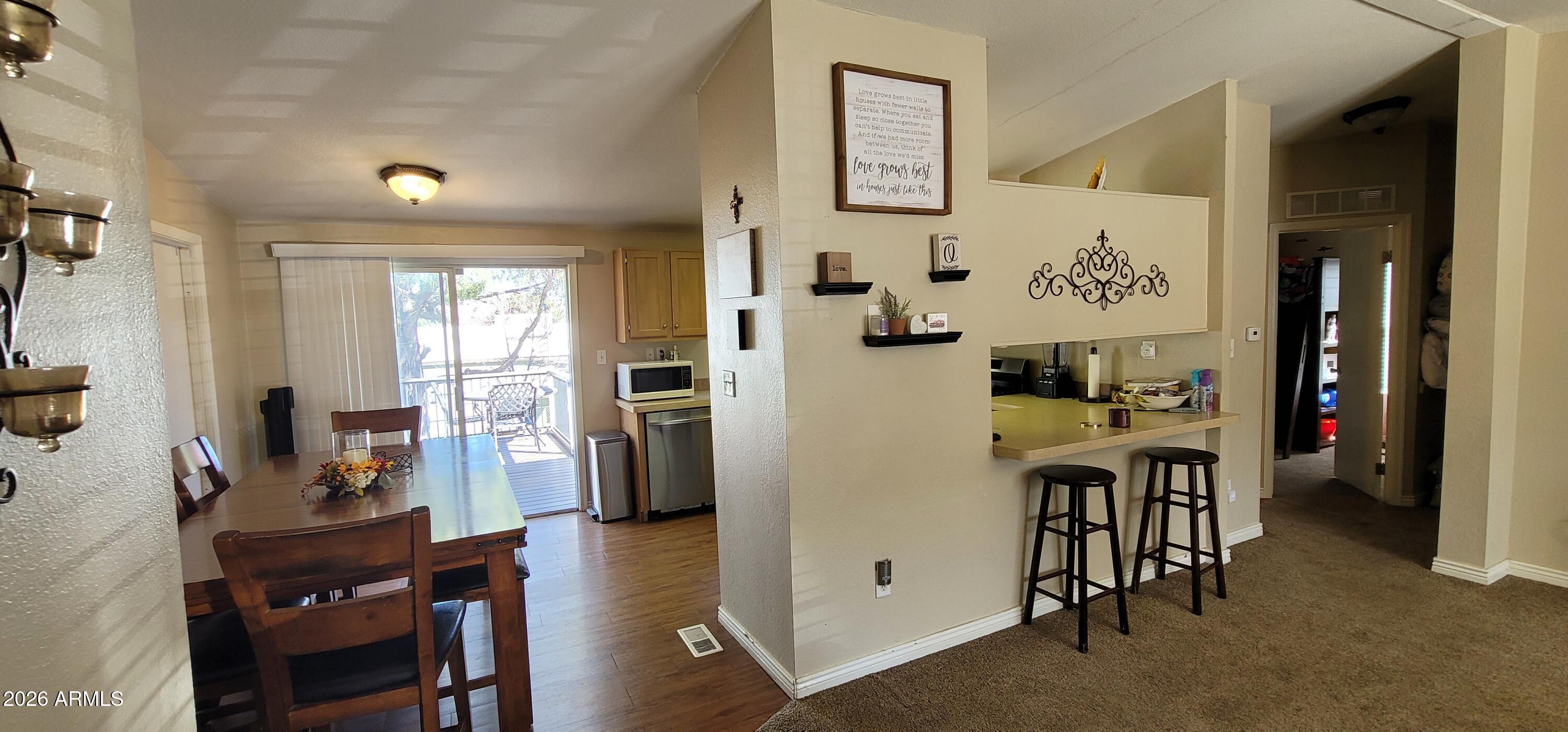 112 East Pine Street Payson, AZ 85541 - Photo 11 of 58 a view of a dining room with furniture and a chandelier