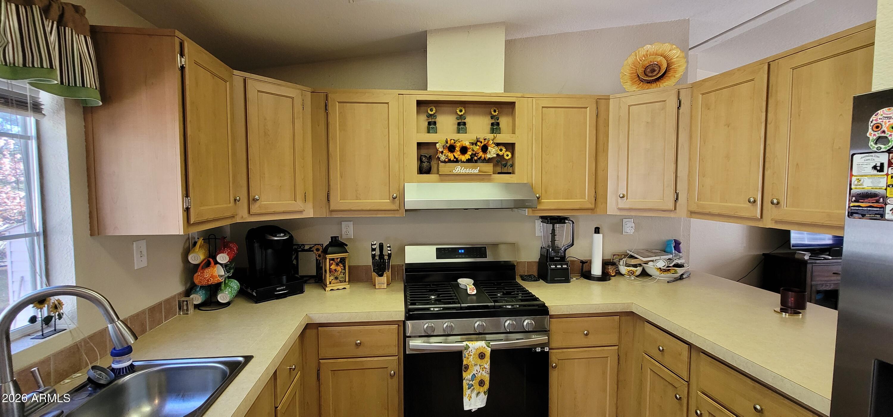 112 East Pine Street Payson, AZ 85541 - Photo 17 of 58 a kitchen with a sink stove and cabinets