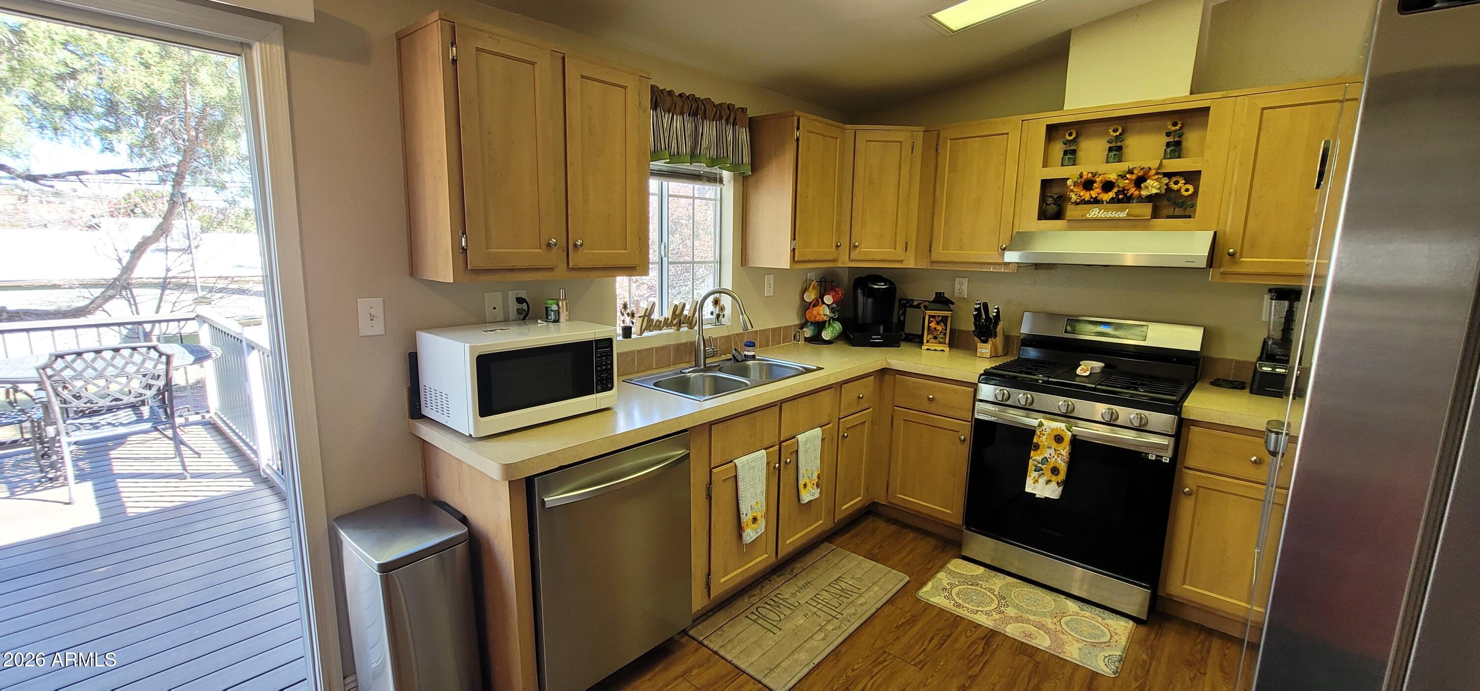112 East Pine Street Payson, AZ 85541 - Photo 18 of 58 a kitchen with a sink stove and cabinets