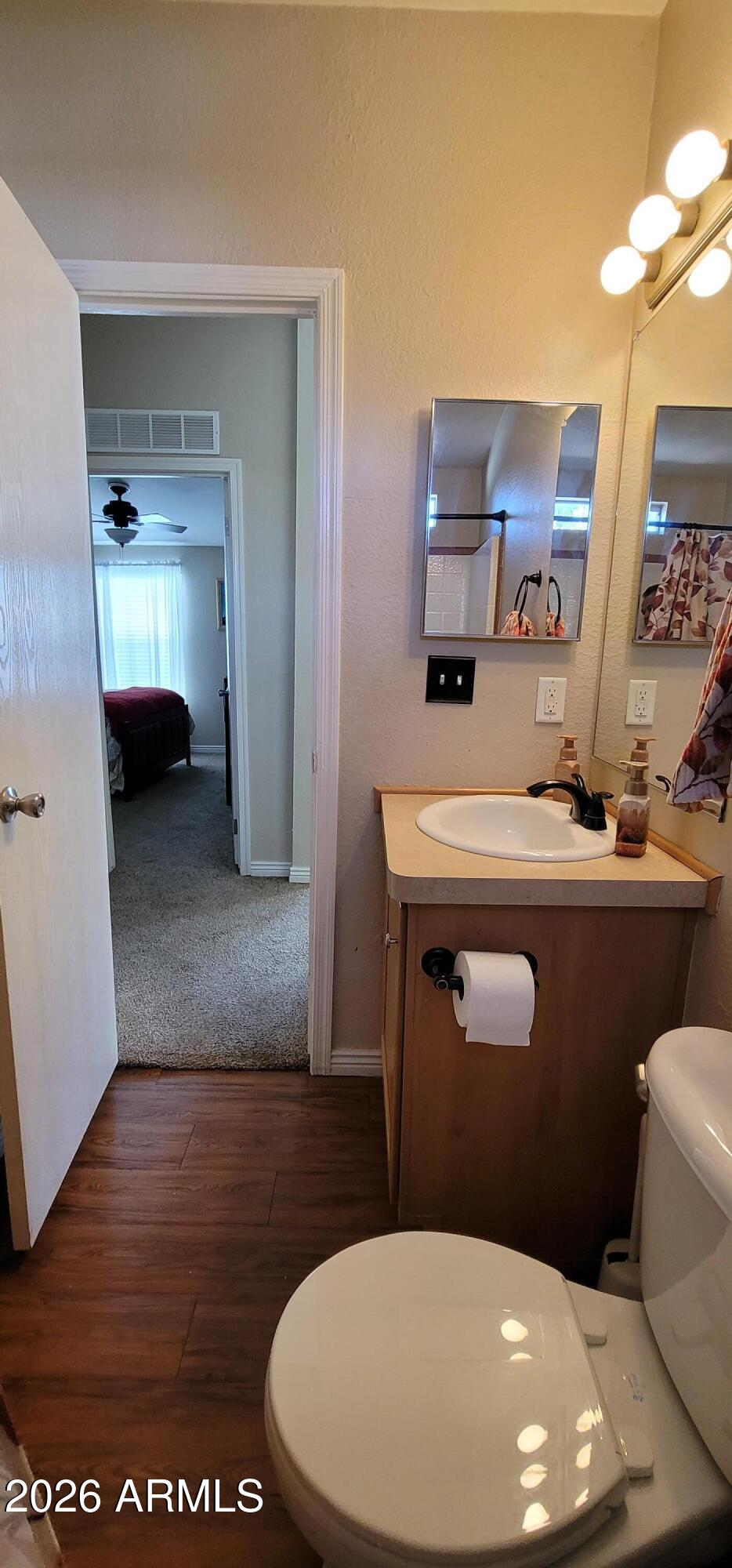 112 East Pine Street Payson, AZ 85541 - Photo 22 of 58 a bathroom with a toilet a sink and mirror