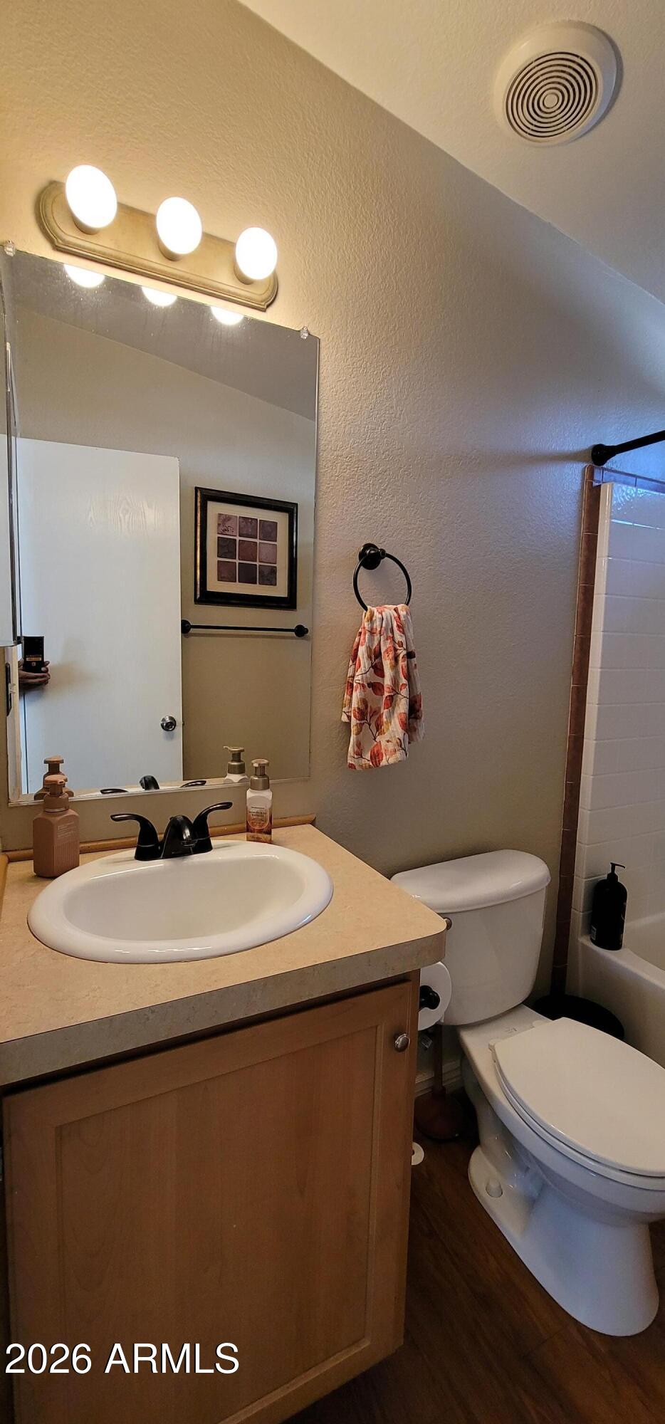 112 East Pine Street Payson, AZ 85541 - Photo 23 of 58 a bathroom with a granite countertop toilet sink and mirror