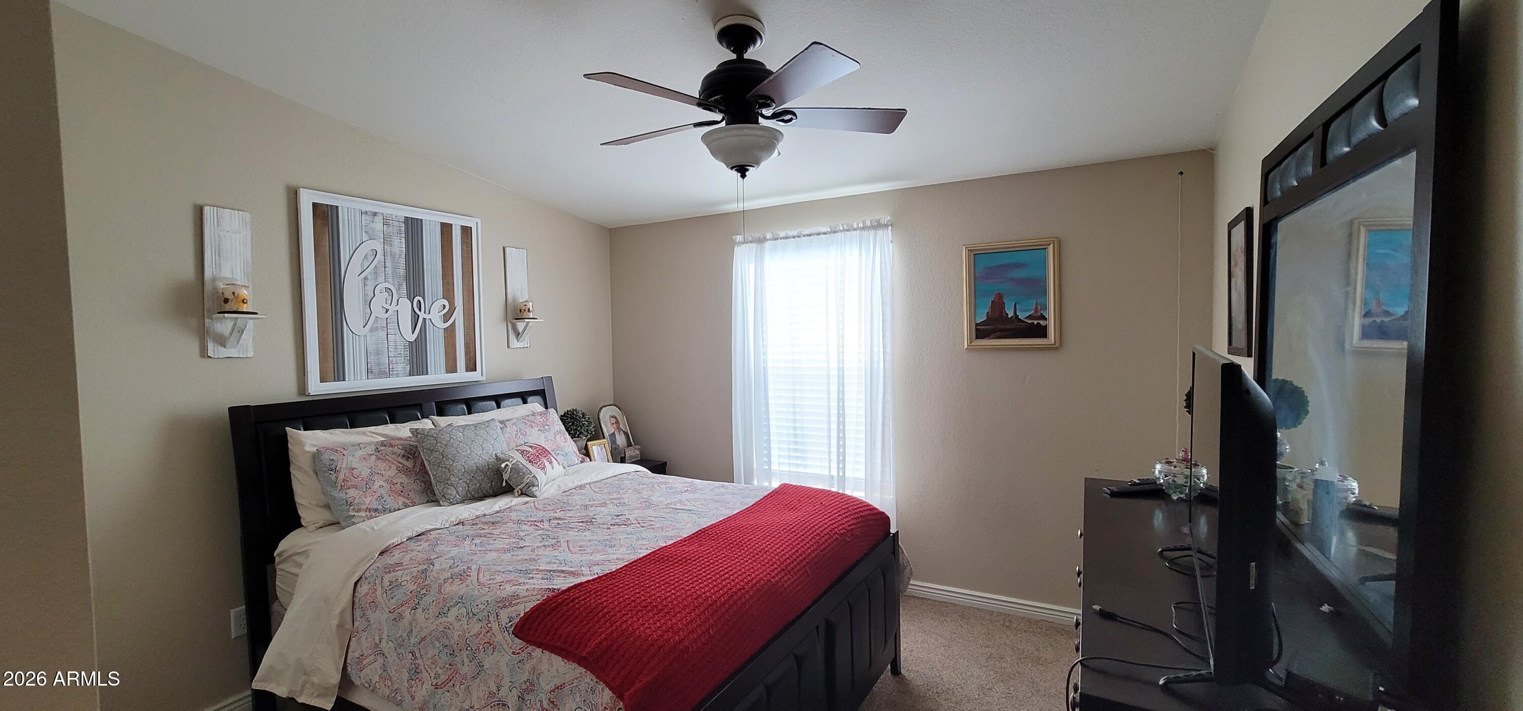 112 East Pine Street Payson, AZ 85541 - Photo 26 of 58 a bedroom with a bed and a chandelier