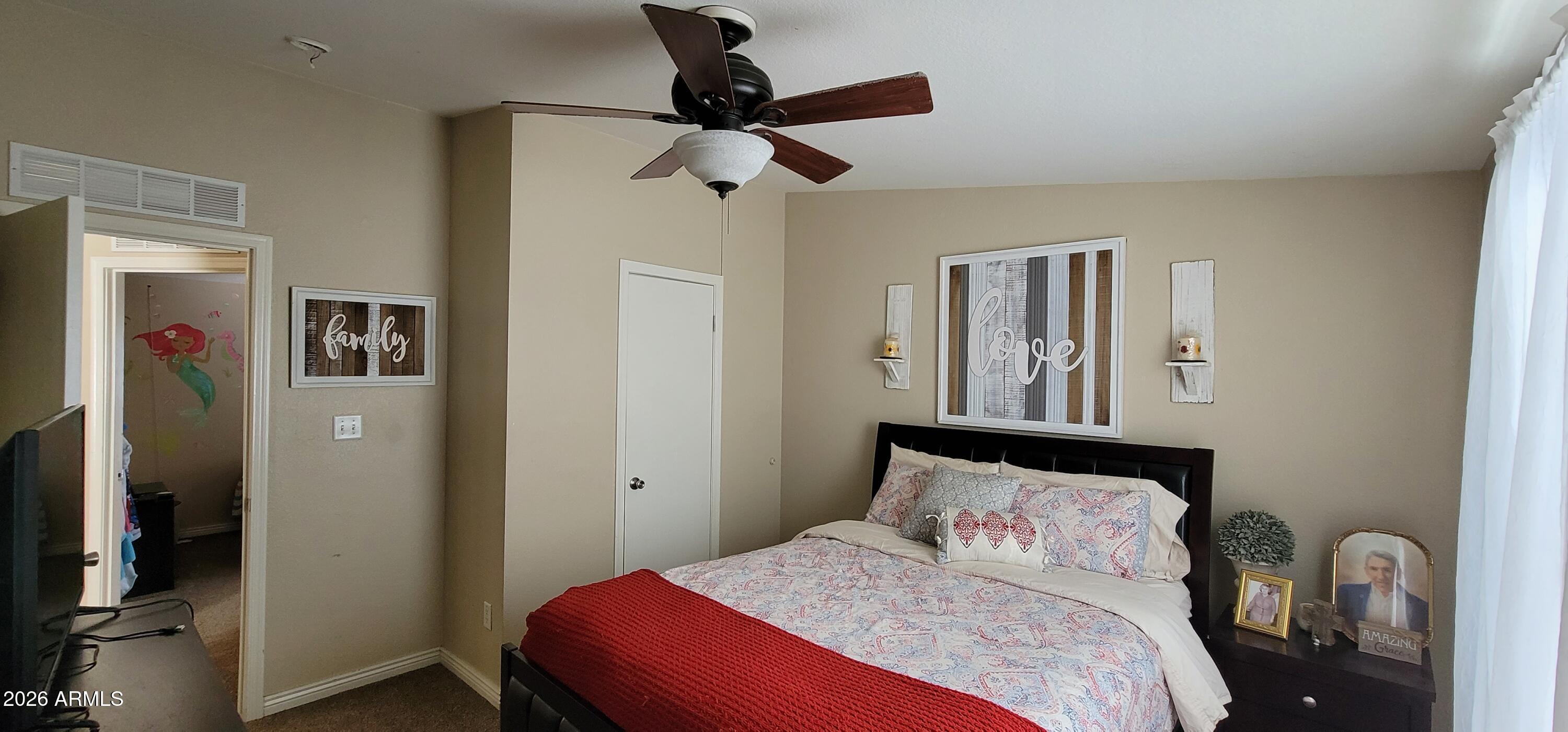 112 East Pine Street Payson, AZ 85541 - Photo 27 of 58 a bedroom with a bed and a chandelier