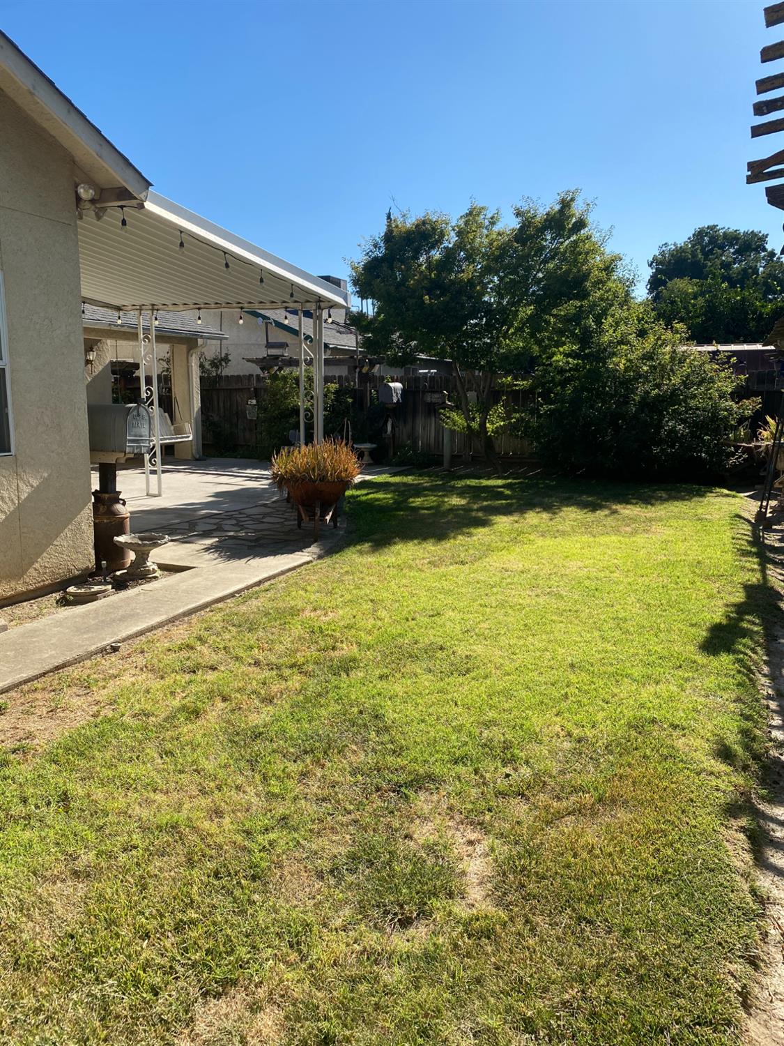 609 Merlot Avenue Madera, CA 93637 - Photo 40 of 45 a view of a swimming pool with a lawn chairs under an umbrella