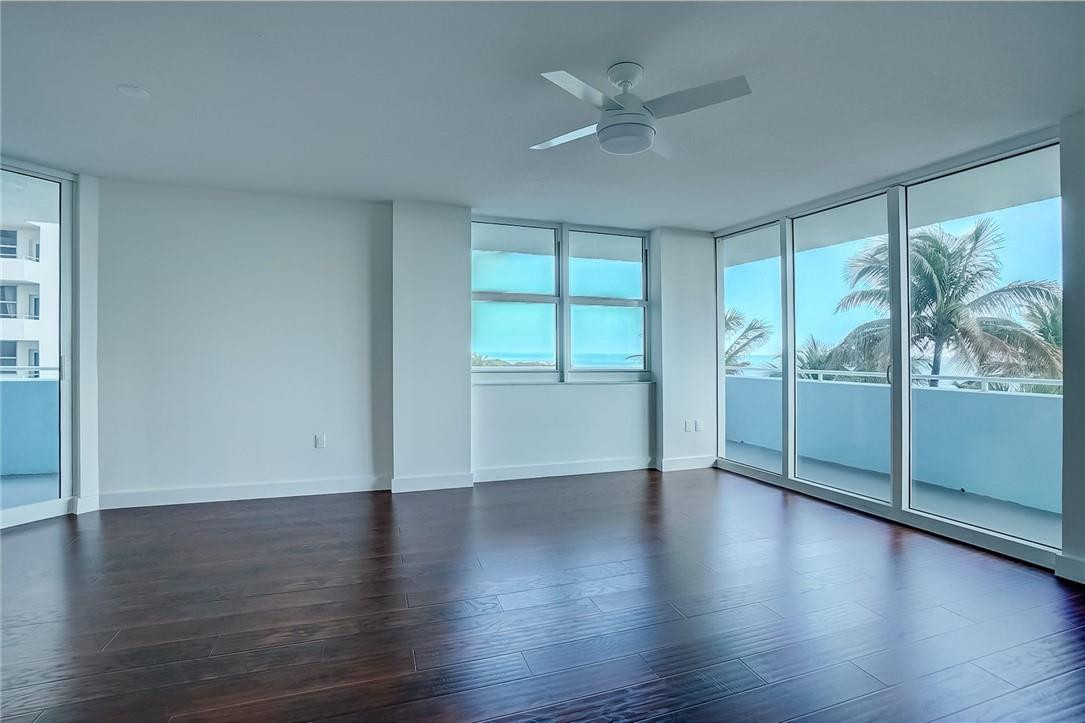 9201 Collins Avenue, Unit 326 Surfside, FL 33154 - Photo 11 of 41 a view of an empty room with wooden floor and a window