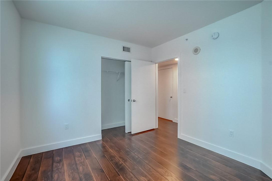 9201 Collins Avenue, Unit 326 Surfside, FL 33154 - Photo 16 of 41 a view of an empty room with wooden floor