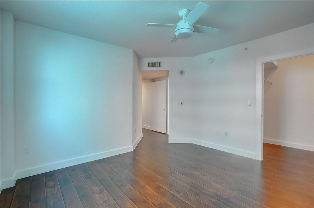 9201 Collins Avenue, Unit 326 Surfside, FL 33154 - Photo 18 of 41 an empty room with wooden floor and ceiling fan