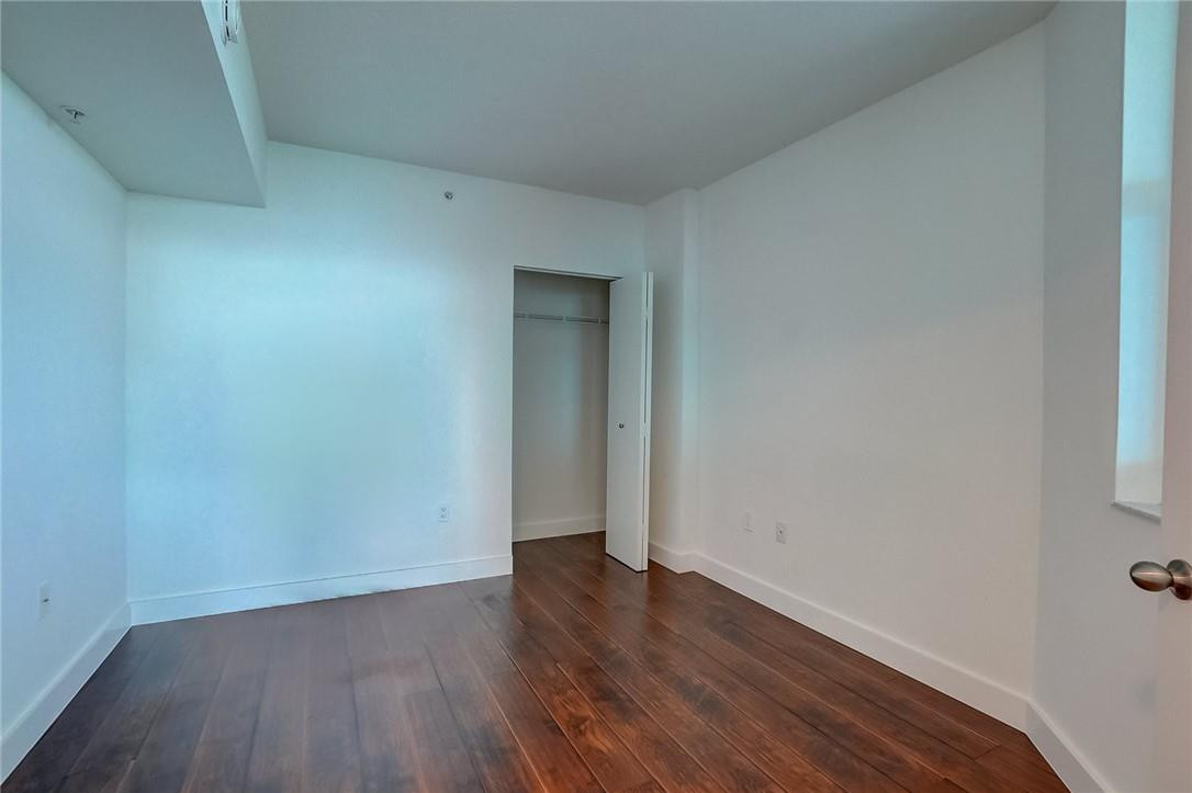 9201 Collins Avenue, Unit 326 Surfside, FL 33154 - Photo 3 of 41 an empty room with wooden floor and closet