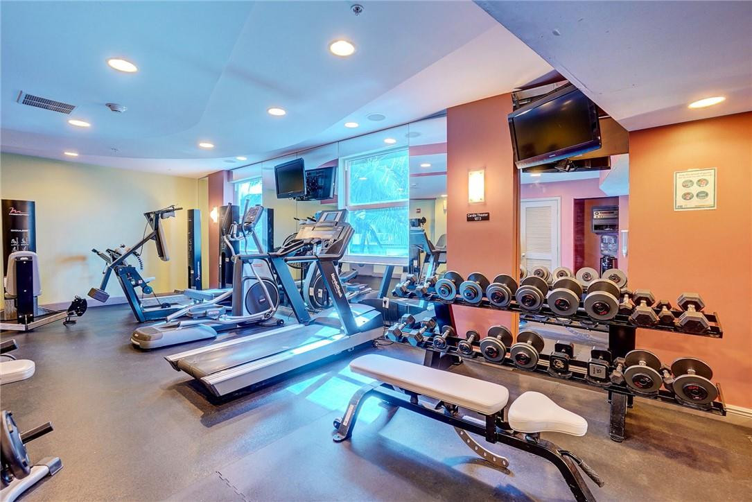 9201 Collins Avenue, Unit 326 Surfside, FL 33154 - Photo 35 of 41 a room with gym equipment and wooden floor
