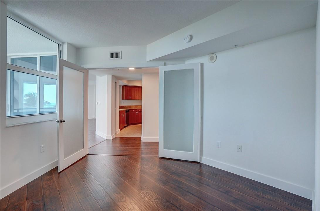 9201 Collins Avenue, Unit 326 Surfside, FL 33154 - Photo 4 of 41 an empty room with wooden floor and closet