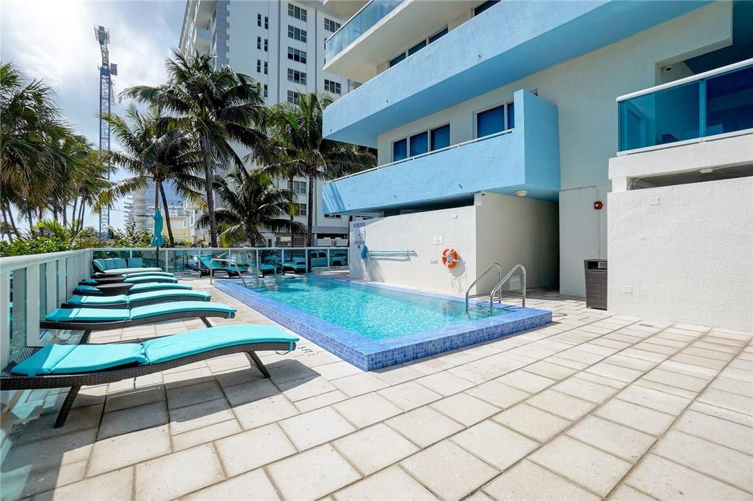 9201 Collins Avenue, Unit 326 Surfside, FL 33154 - Photo 41 of 41 a front view of a house with a yard