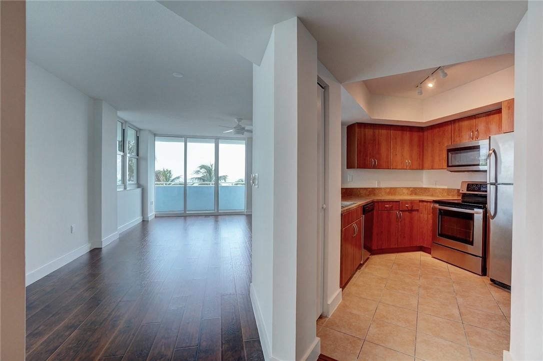 9201 Collins Avenue, Unit 326 Surfside, FL 33154 - Photo 5 of 41 a kitchen with stainless steel appliances granite countertop a refrigerator and a stove top oven