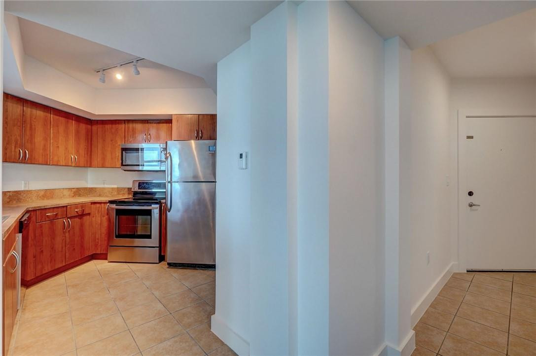 9201 Collins Avenue, Unit 326 Surfside, FL 33154 - Photo 6 of 41 a kitchen with stainless steel appliances granite countertop a stove and a refrigerator