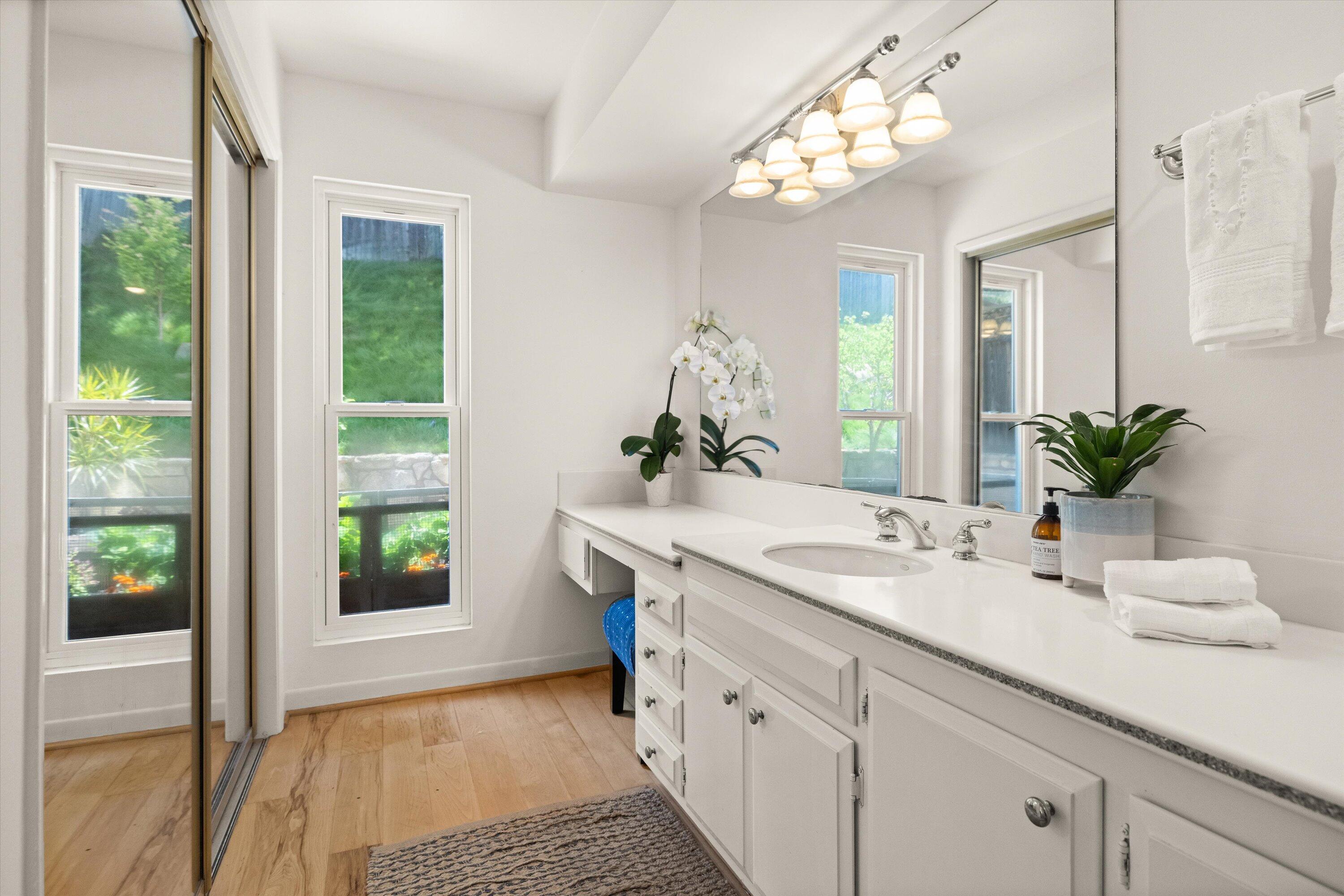 927 Randolph Road Santa Barbara, CA 93111 - Photo 12 of 25 a bathroom with a double vanity sink and a mirror