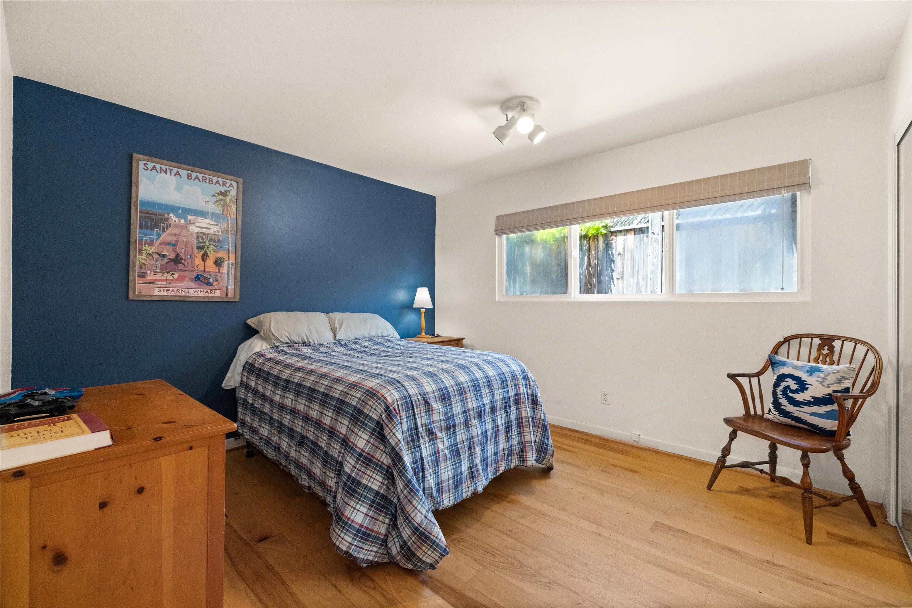 927 Randolph Road Santa Barbara, CA 93111 - Photo 14 of 25 a bedroom with a bed and wooden floor