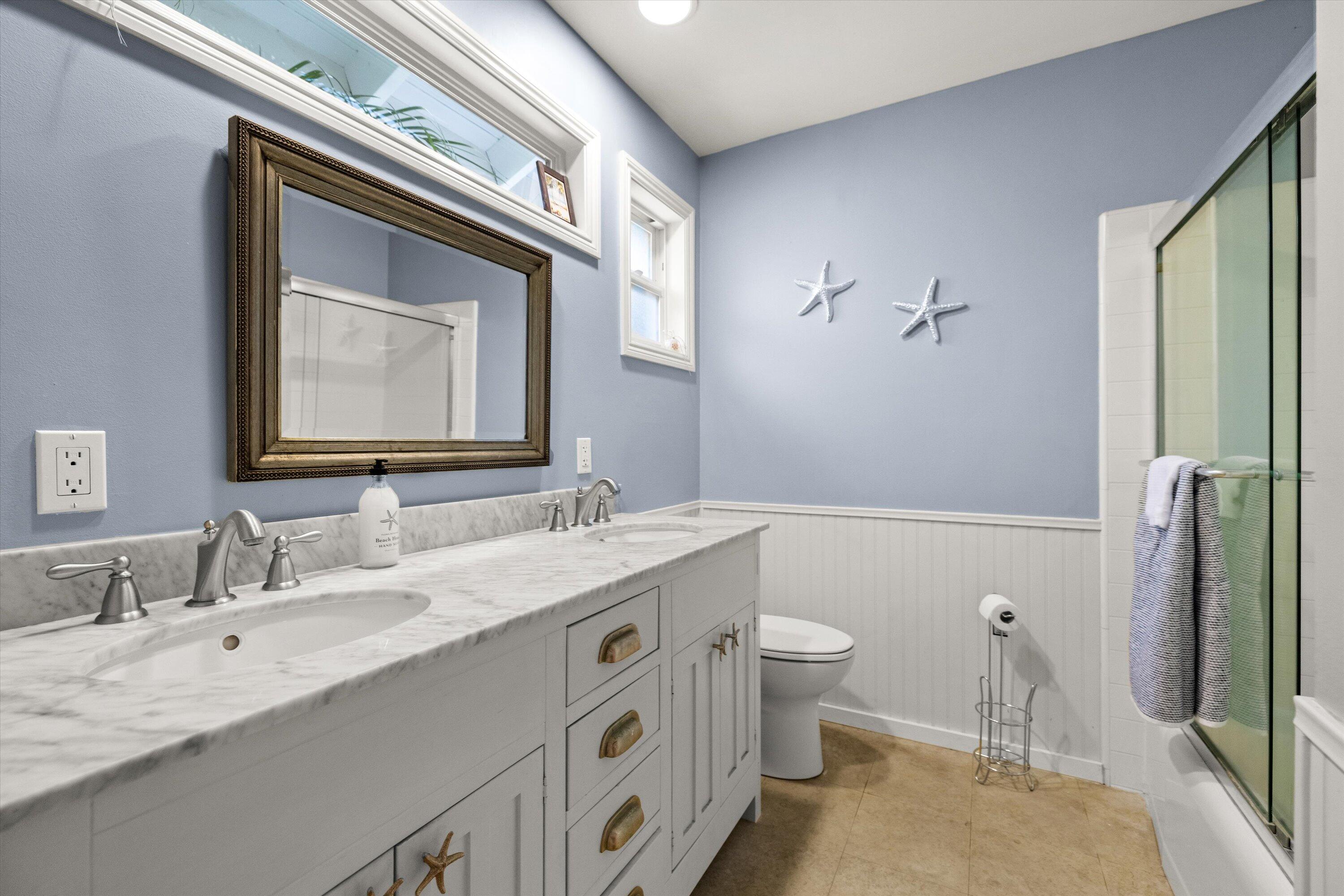 927 Randolph Road Santa Barbara, CA 93111 - Photo 15 of 25 a bathroom with a double vanity sink toilet and a mirror