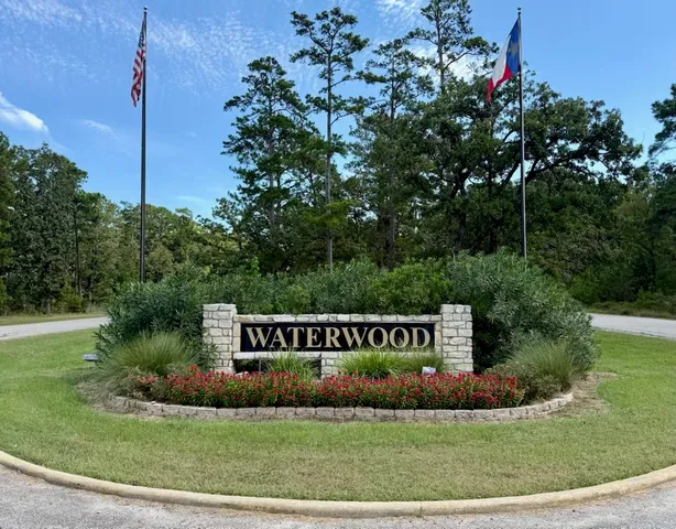 a view of a park that has a sign board