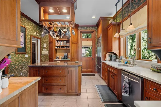a kitchen with a sink and a stove top oven