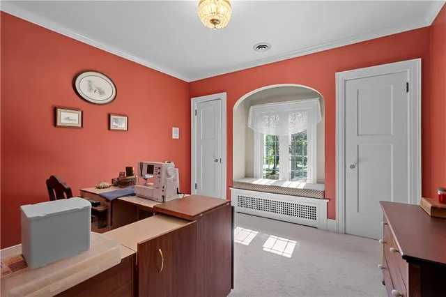 a bed sitting in a bedroom next to a window