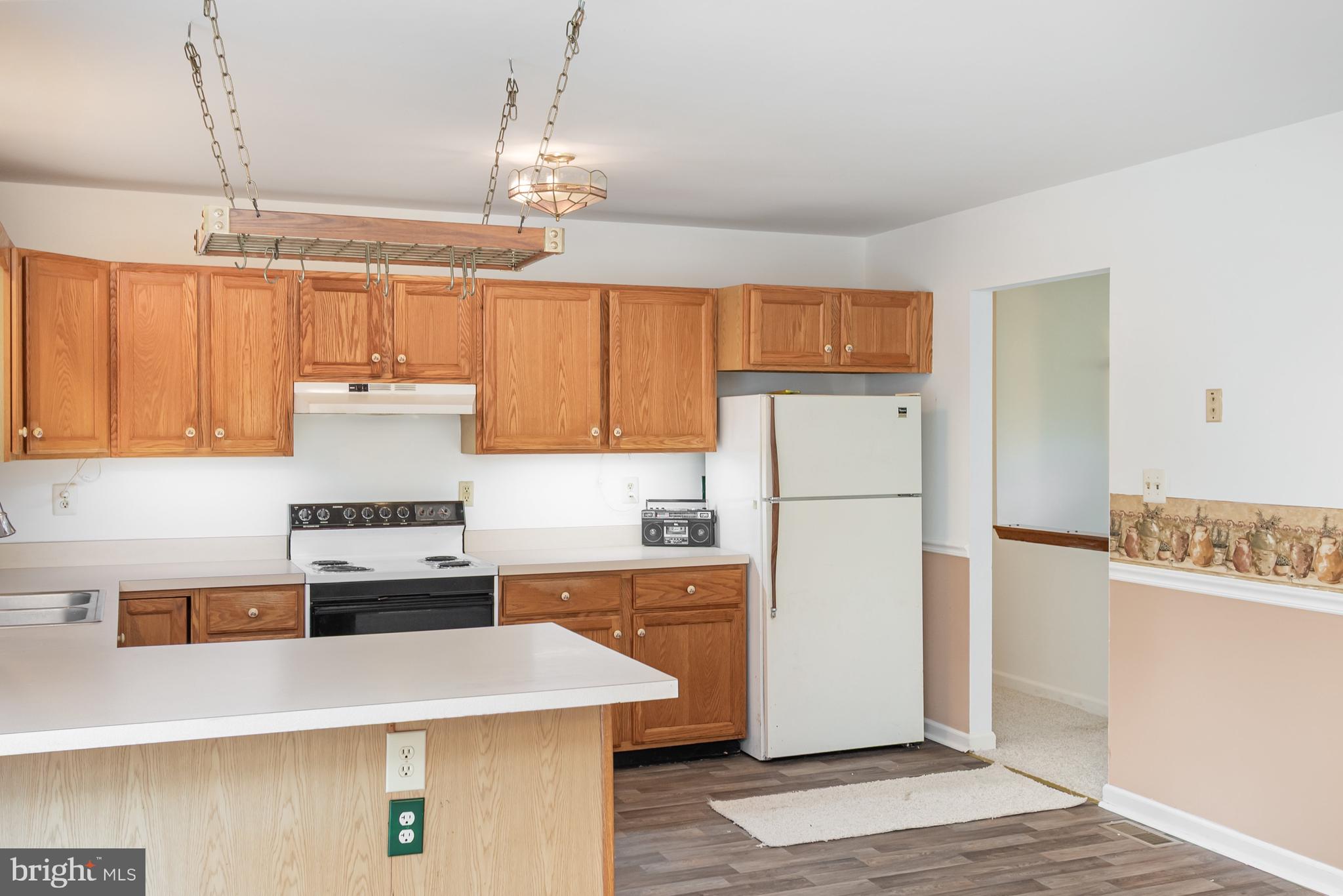 21 Country Lane Colora, MD 21917 - Photo 14 of 68 a kitchen with a refrigerator a stove a sink a counter space and wooden floor