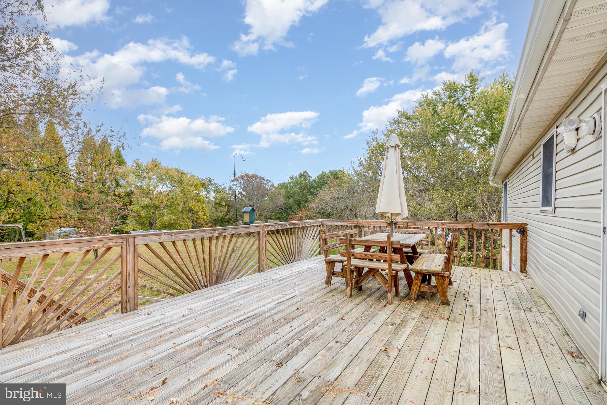 21 Country Lane Colora, MD 21917 - Photo 33 of 68 a view of a roof deck with table and chairs a barbeque with wooden floor and fence