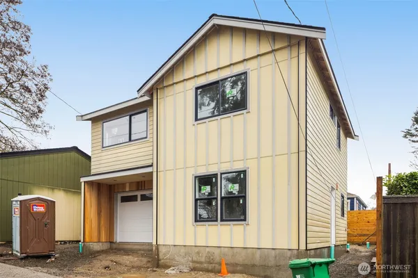a view of a house with wooden fence