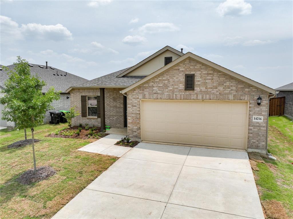 14216 Aberavon Drive Pilot Point, TX 76258 - Photo 1 of 2 a front view of a house with a yard and garage