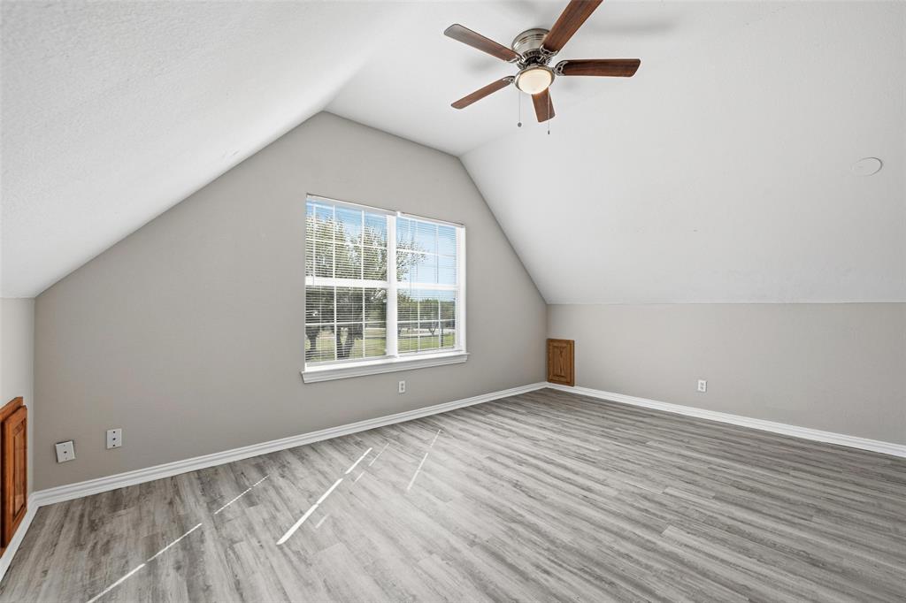 213 Private Road 4573, Unit 228 Boyd, TX 76023 - Photo 5 of 23 an empty room with wooden floor fan and windows