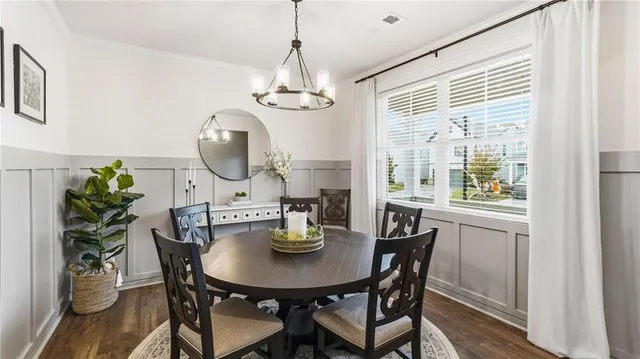 a view of a dining room with furniture window and wooden floor