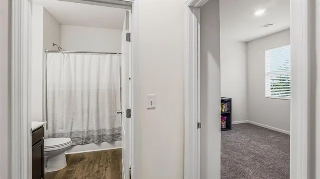 a bathroom with a toilet and a shower