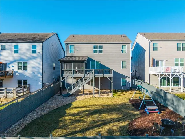 a view of a house with swimming pool and sitting area