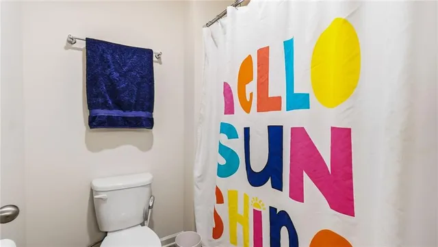 a bathroom with a rug toilet and a sink