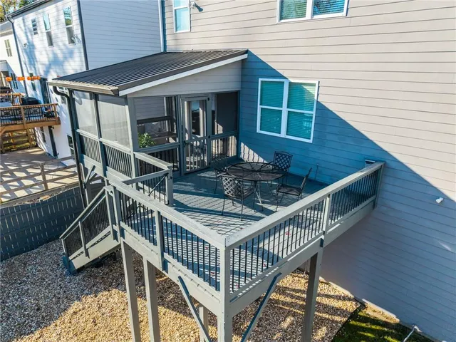 a balcony with table and chairs